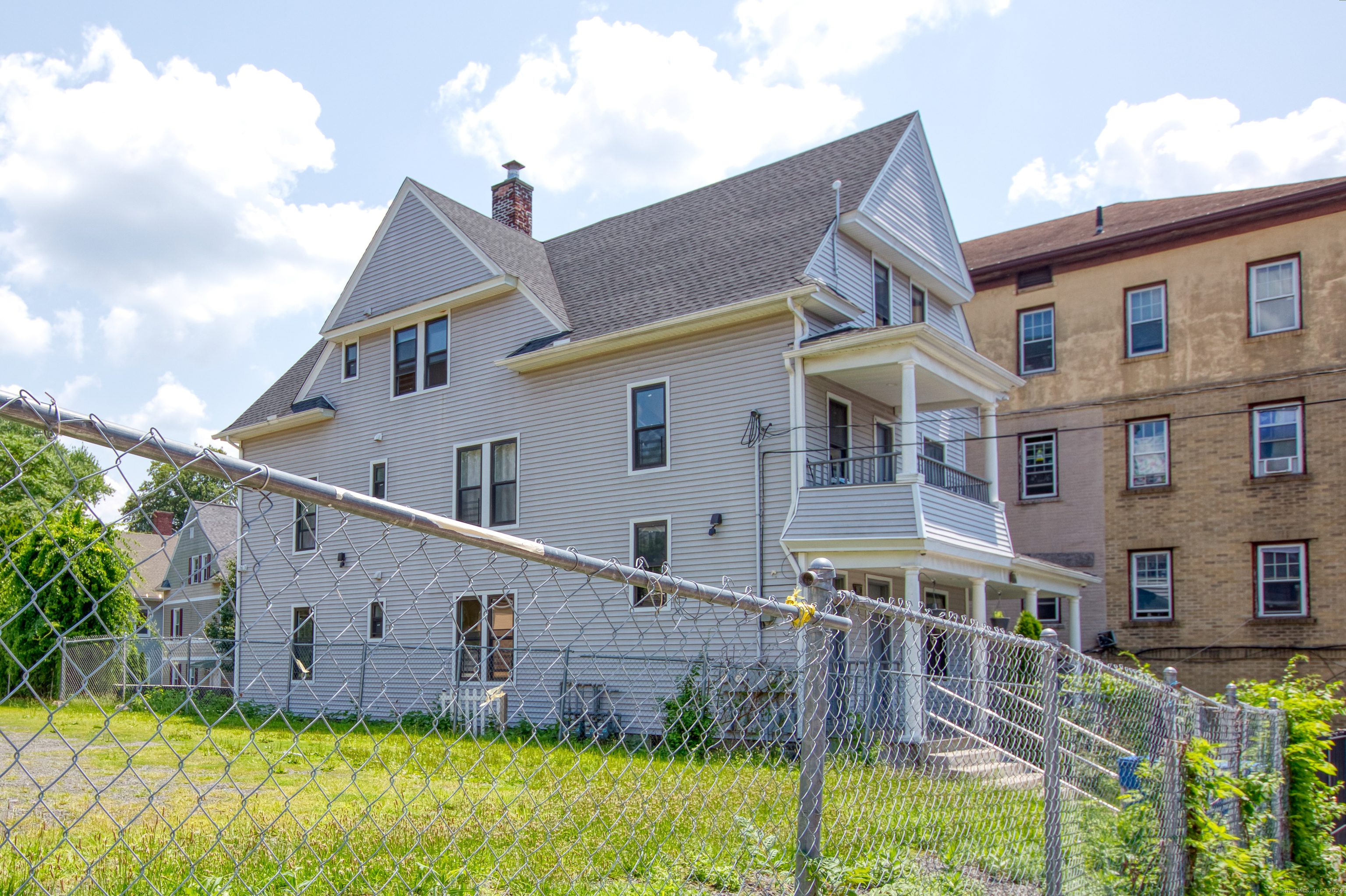 a view of a house with wooden fence