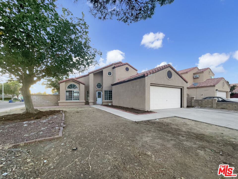 a view of a house with a yard and garage