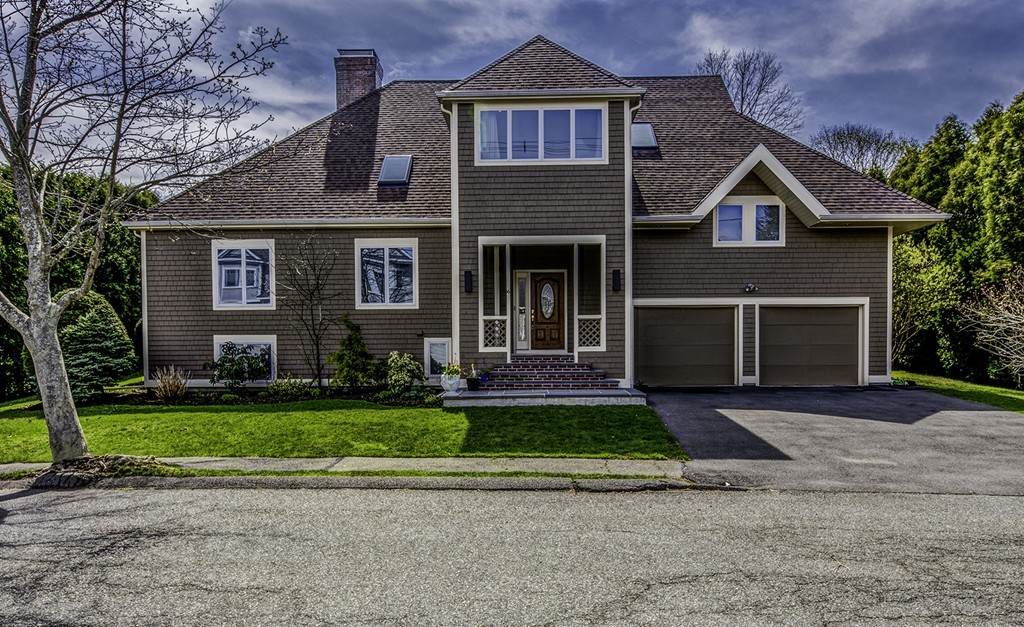 a front view of a house with a yard and garage