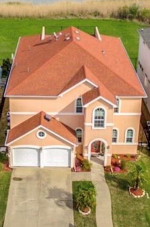 an aerial view of a house with a yard