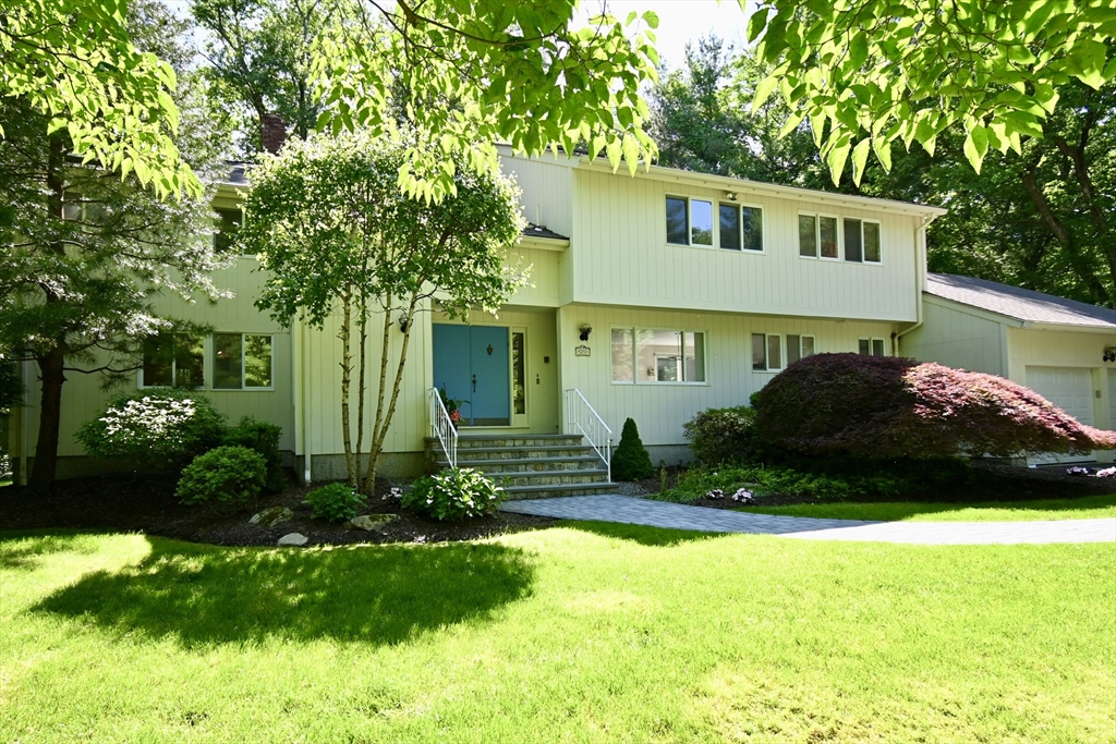 a view of a house with backyard and sitting area