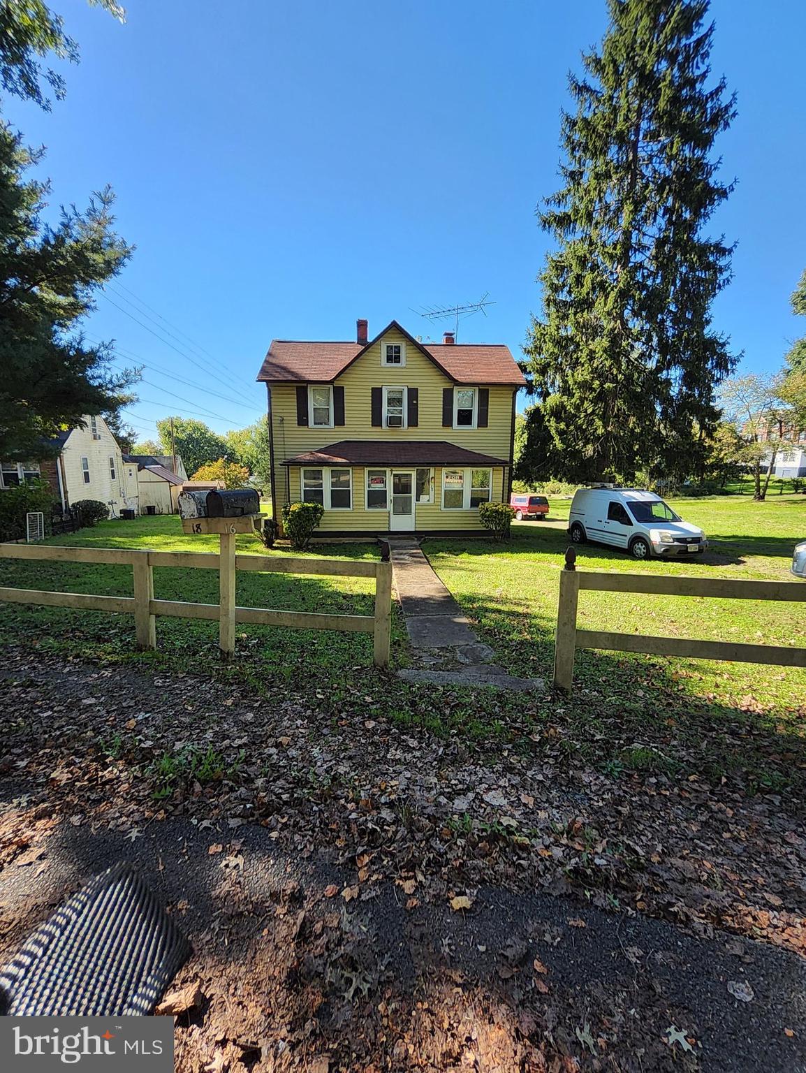 a view of a big house with a big yard