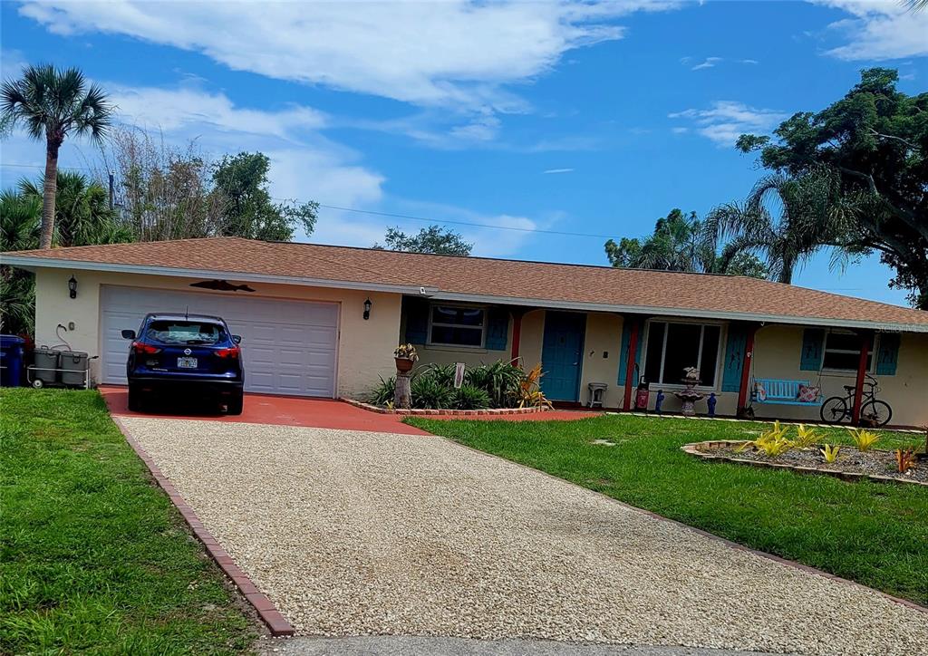 a front view of a house with a garden and yard