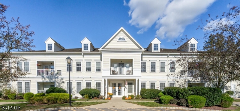 a front view of a residential apartment building with a yard