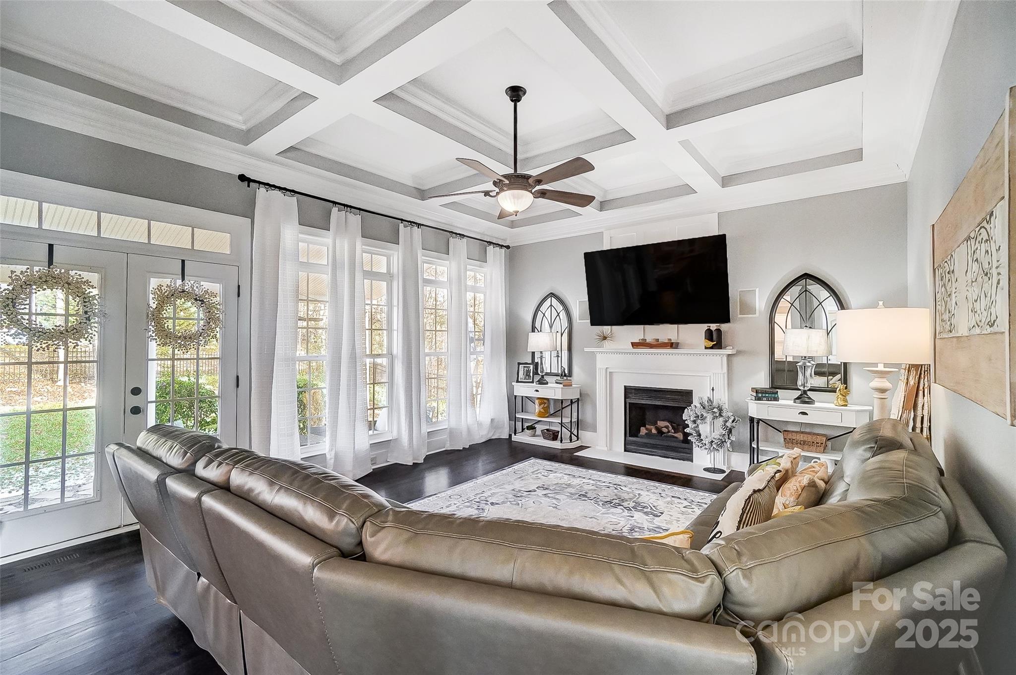 a living room with furniture a fireplace and a flat screen tv