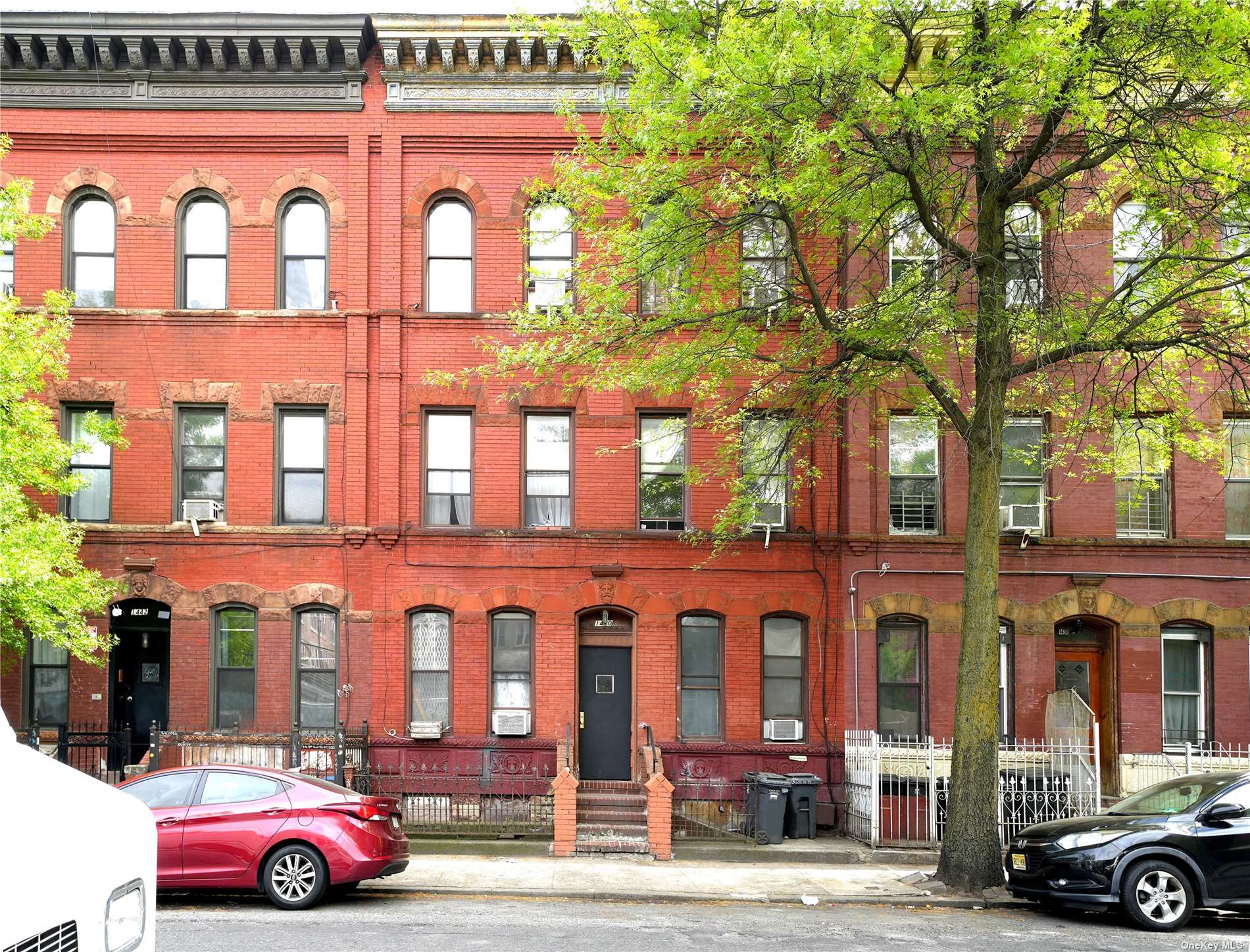 a front view of a residential apartment building with a yard