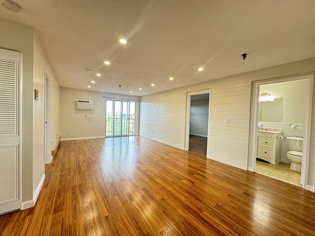 a view of empty room with wooden floor