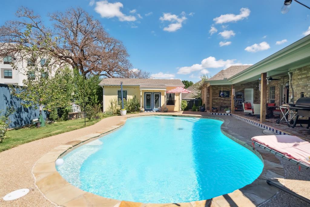 a view of a house with swimming pool and porch