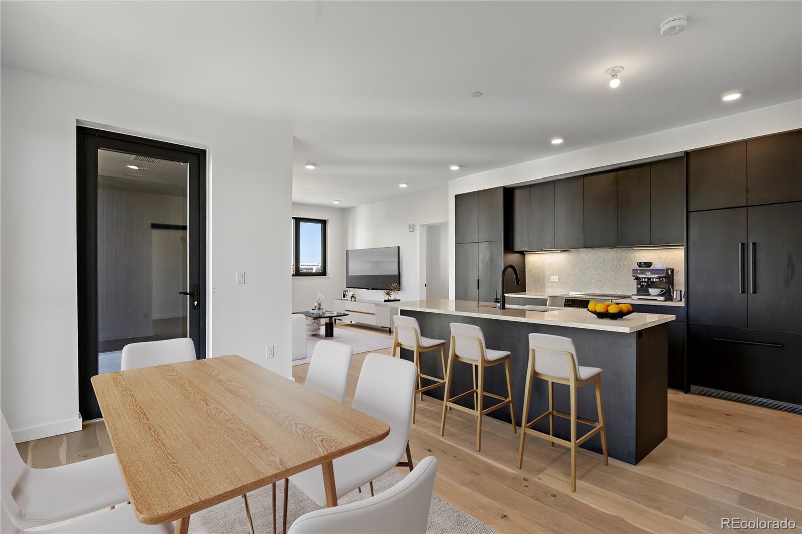 a kitchen with a table chairs stove and refrigerator