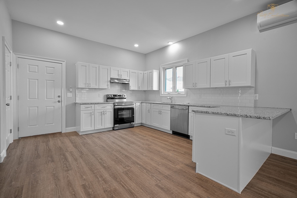 a kitchen with a white cabinets sink and microwave