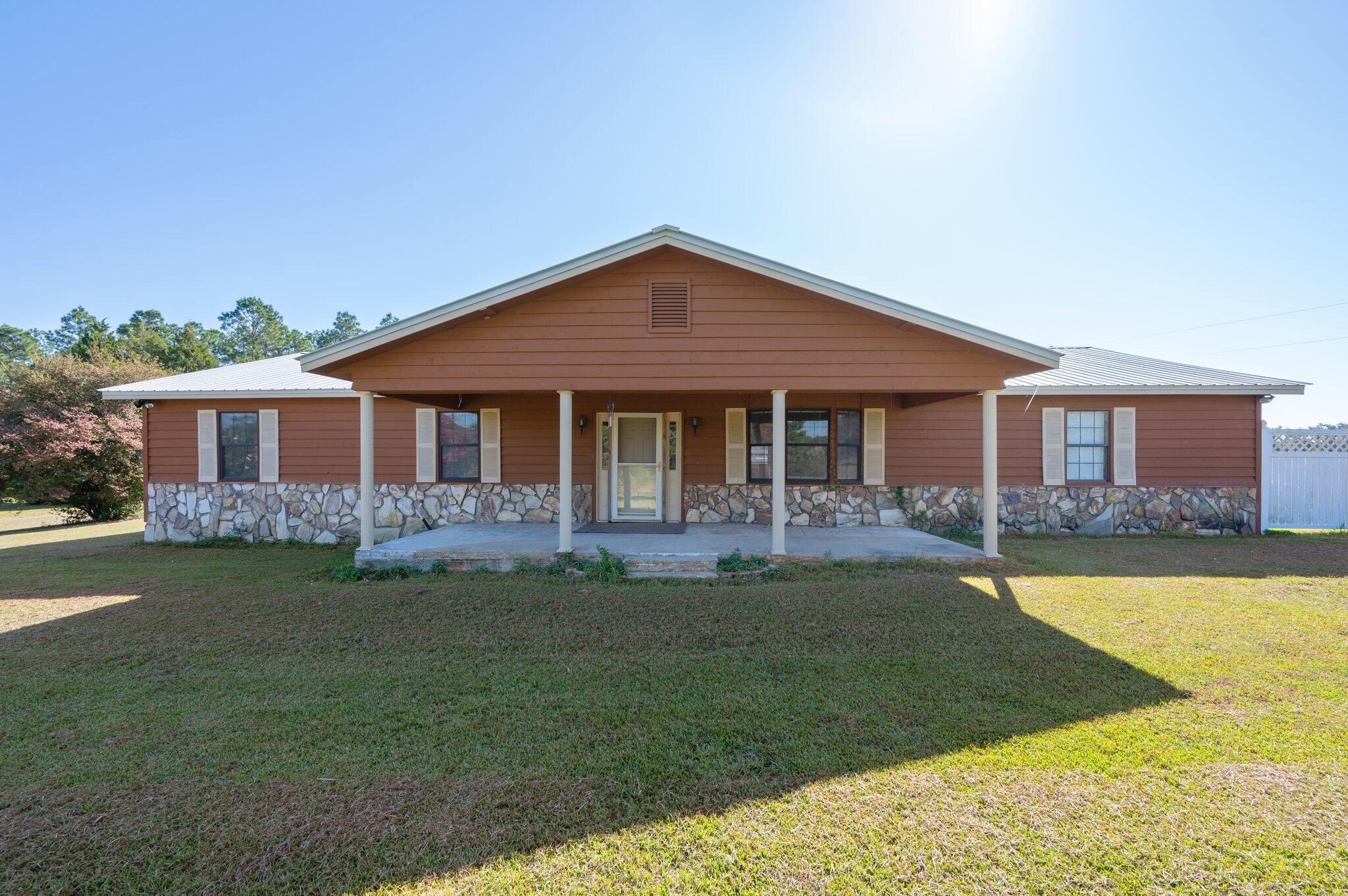 a front view of a house with a garden