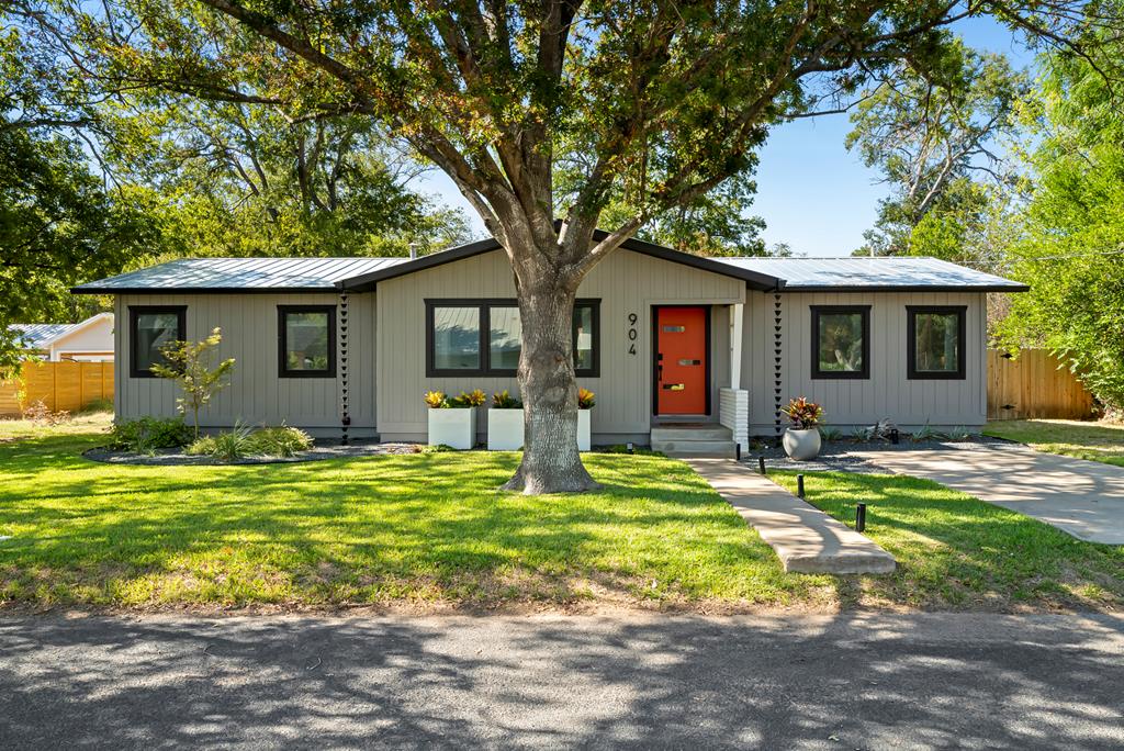 a front view of house with yard and green space