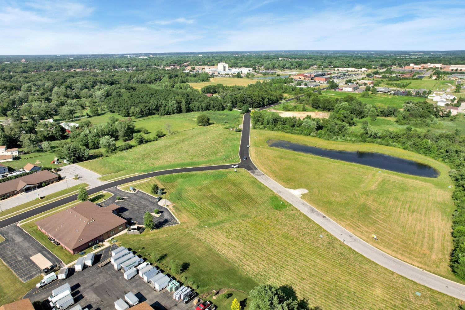 an aerial view of residential houses with outdoor space and swimming pool