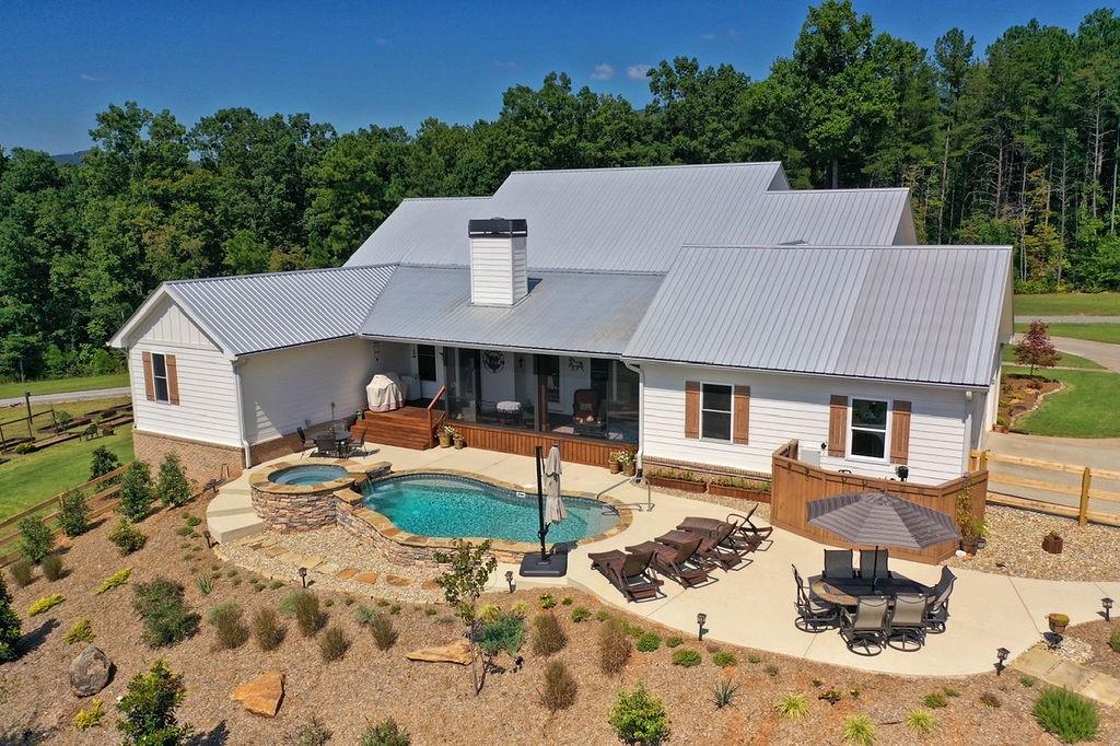 a aerial view of a house with swimming pool and sitting area