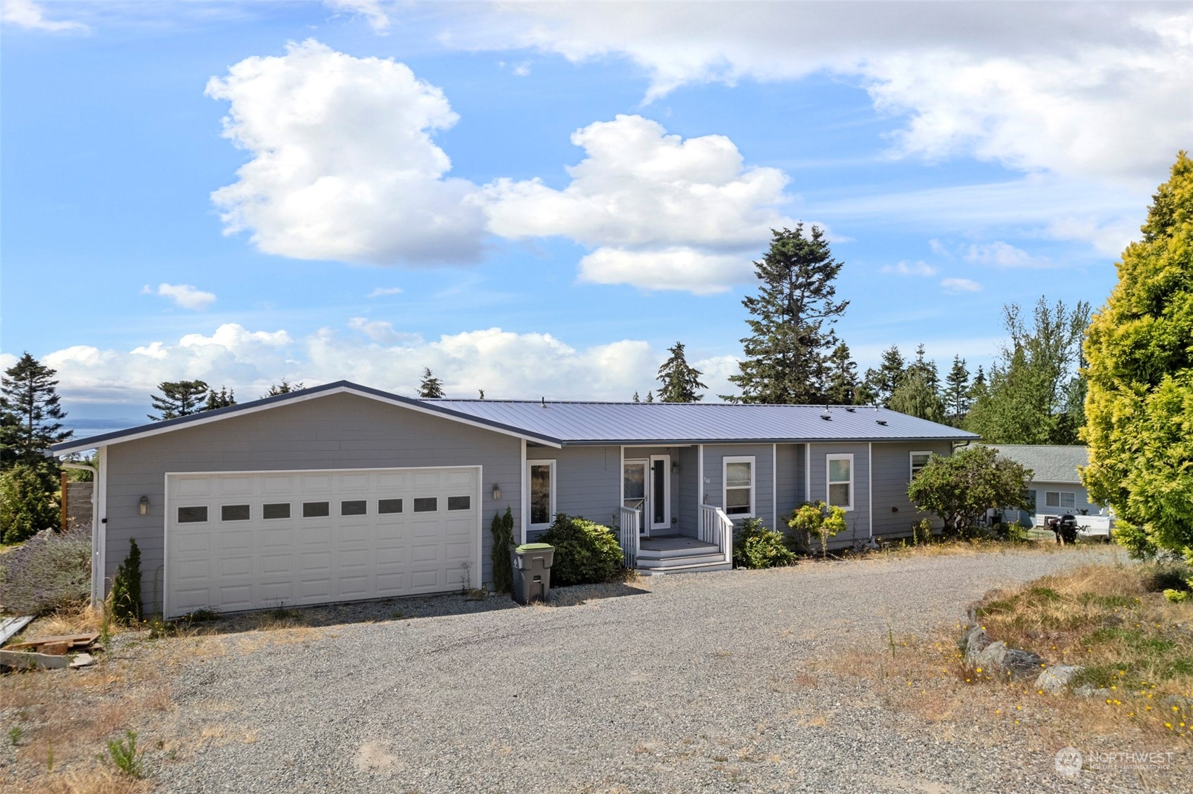 a view of a house with a yard and wooden fence