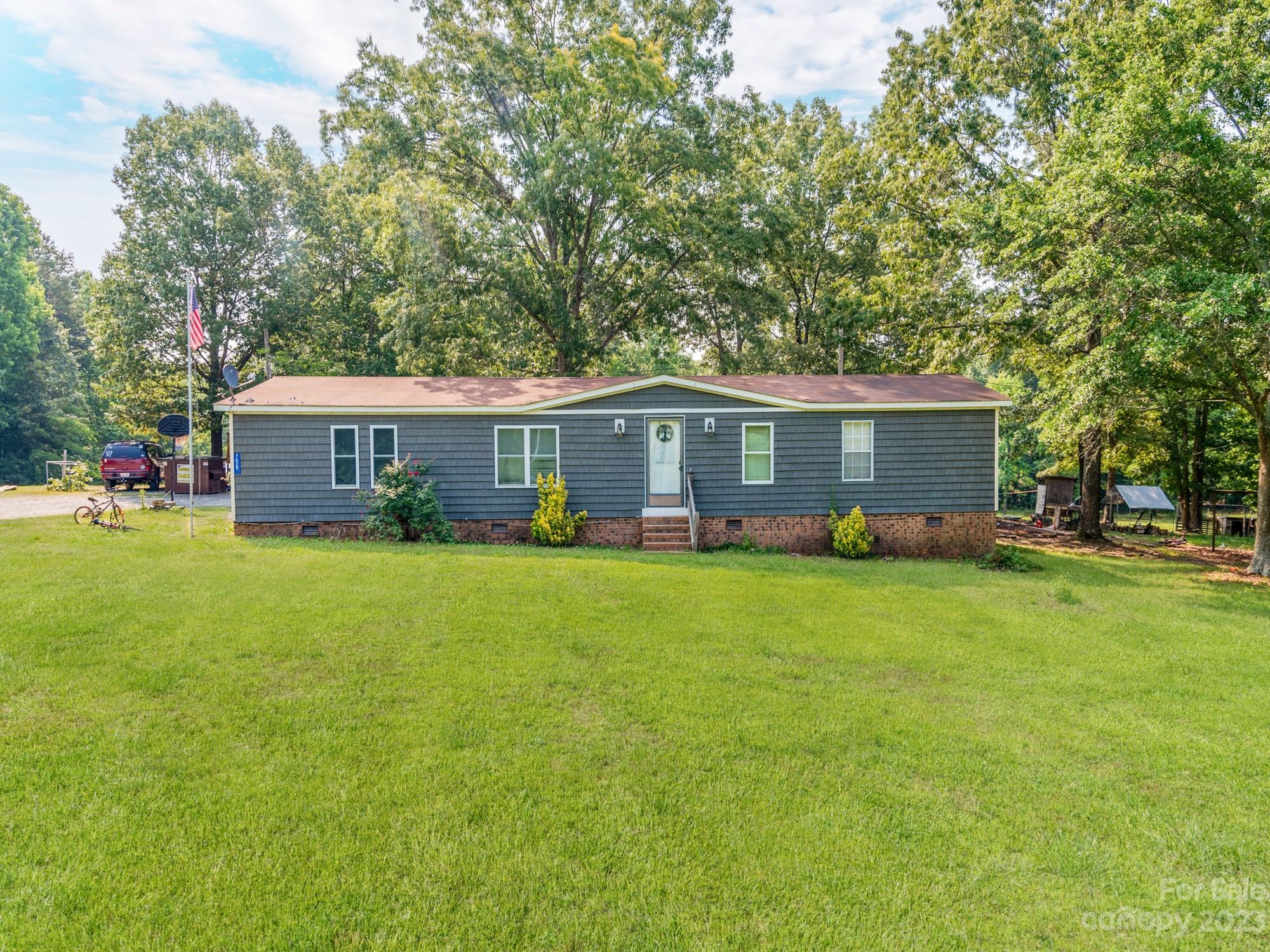 a front view of a house with yard and green space