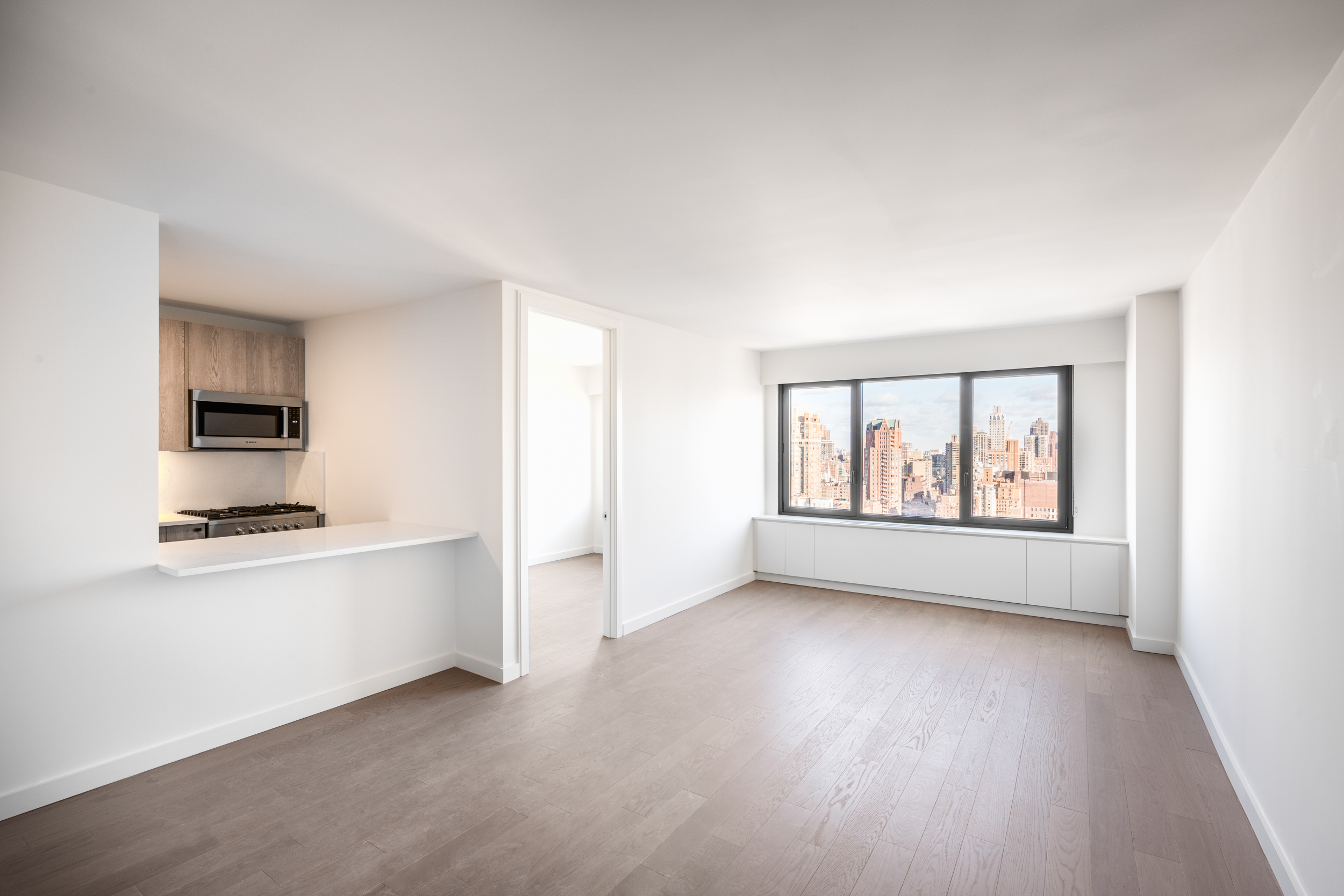 a view of kitchen with wooden floor electronic appliances and window