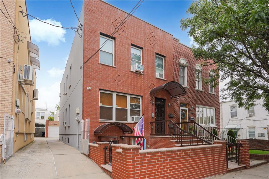 a view of a brick building with many windows