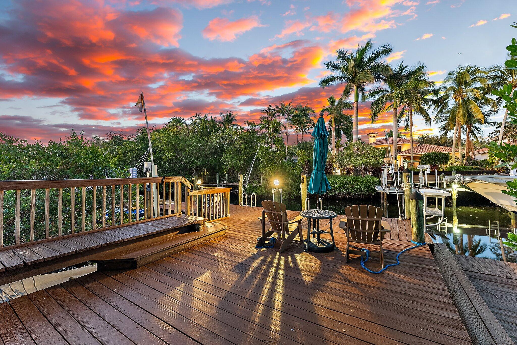 a view of a chair and tables on the wooden deck