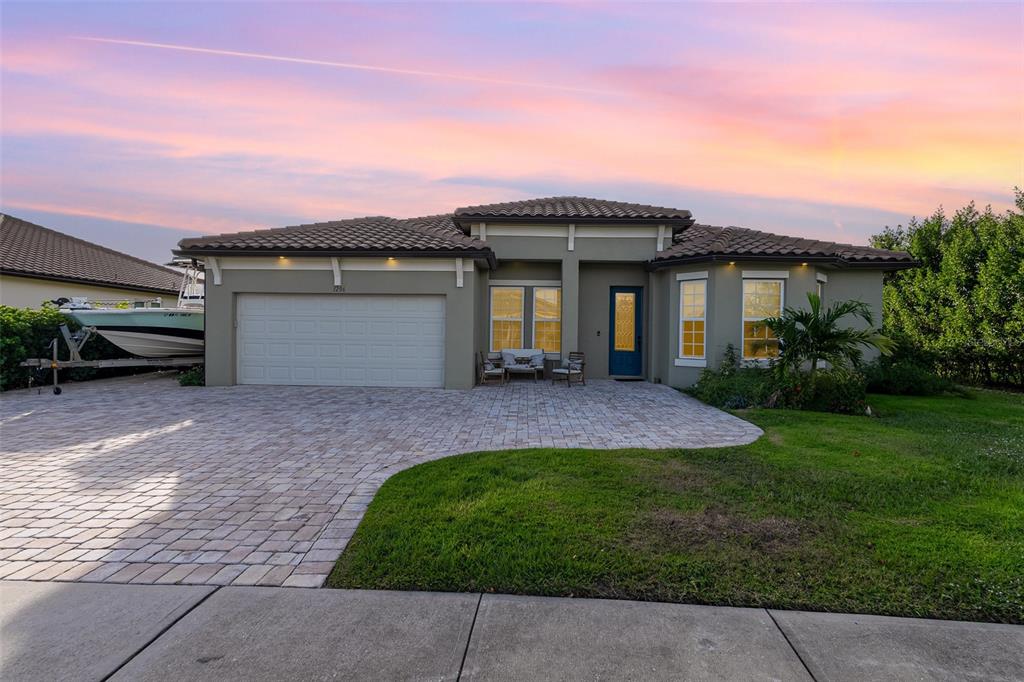 a front view of a house with a yard and garage