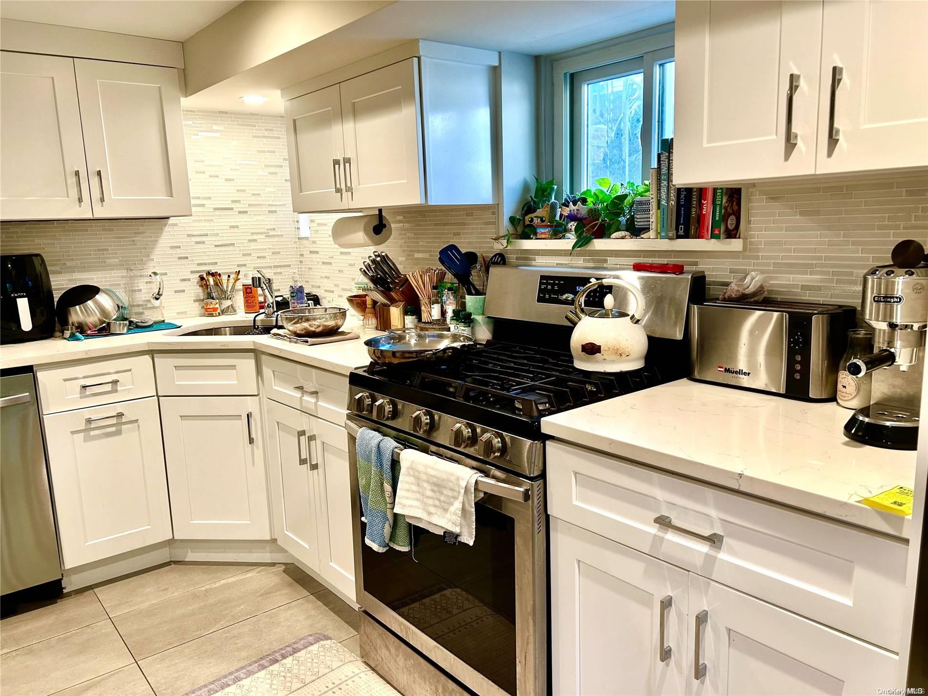 a kitchen with a sink cabinets and stainless steel appliances