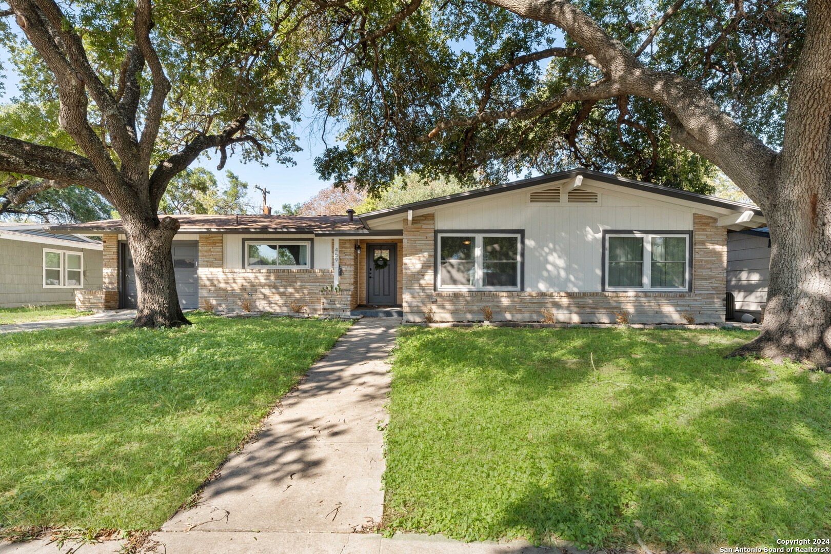 a front view of house with yard and green space