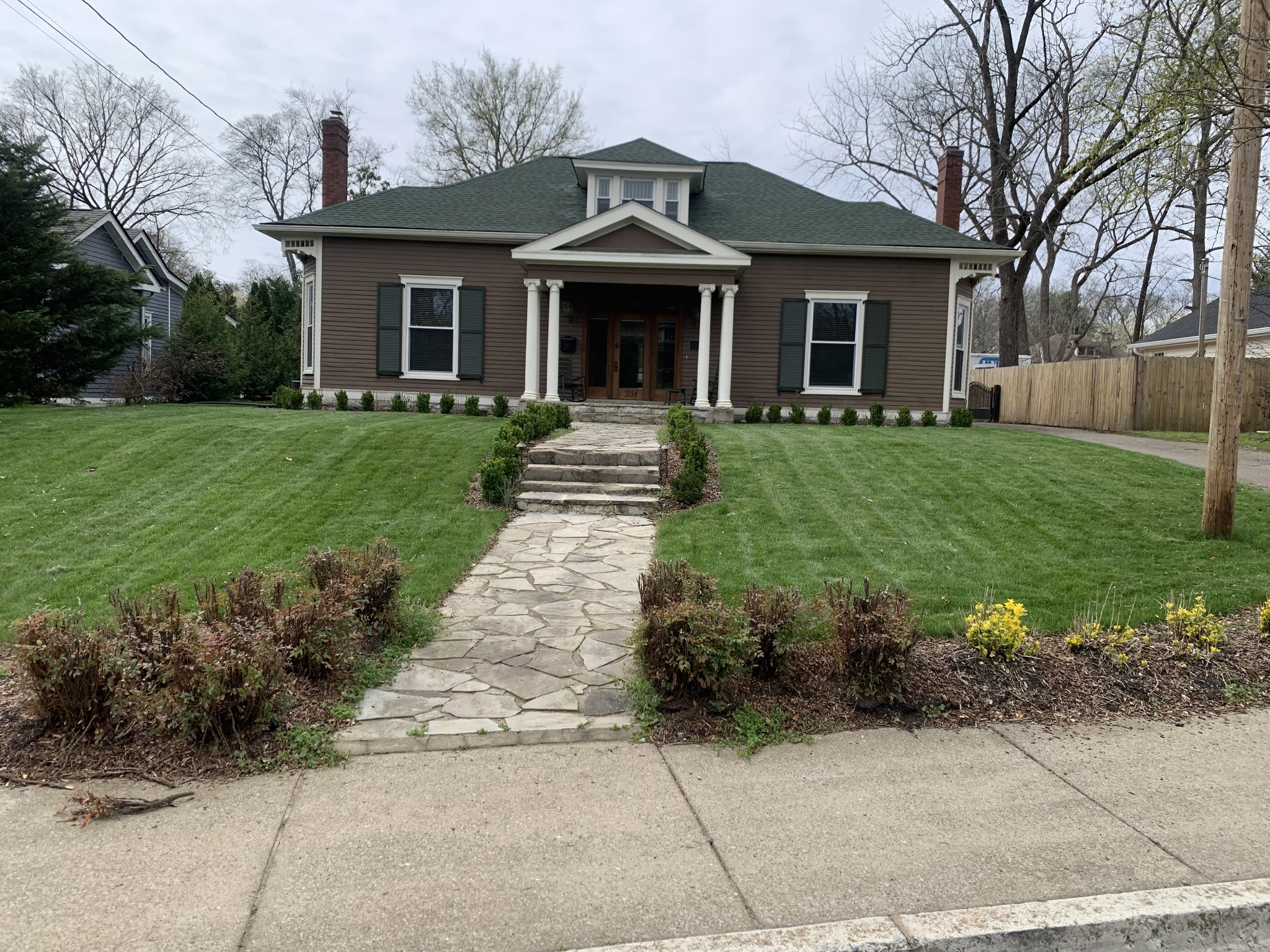 a front view of a house with a garden