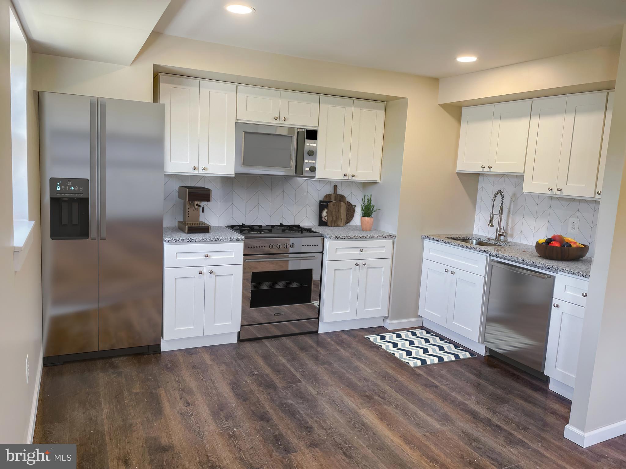 a kitchen with white cabinets and appliances