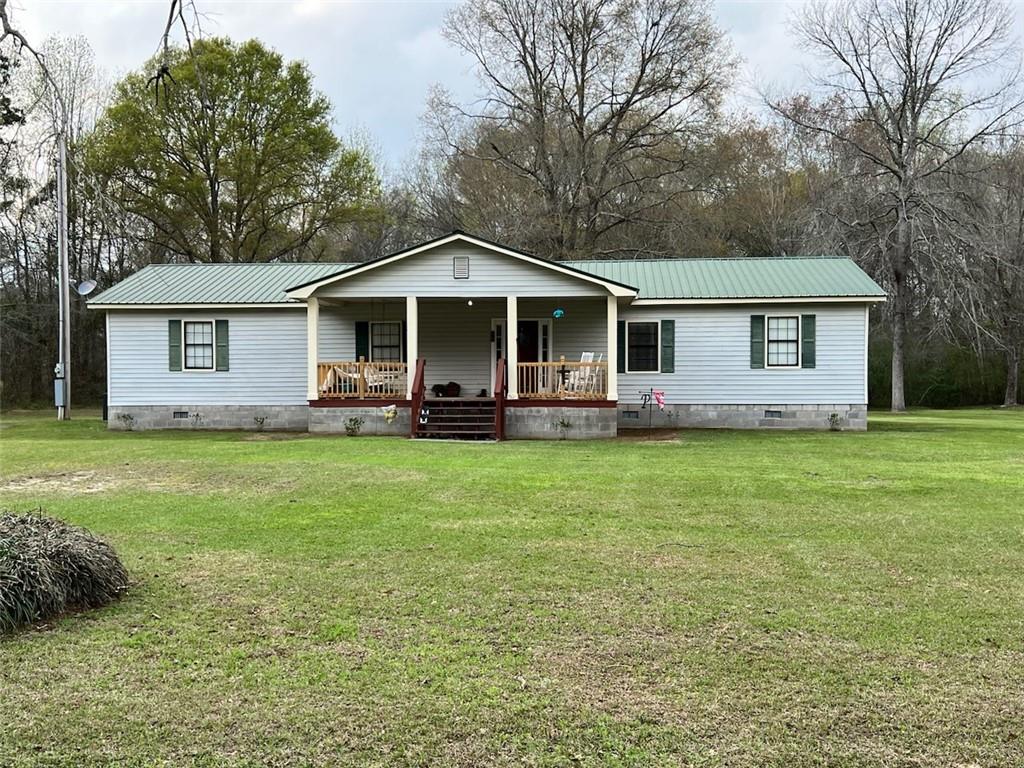 a front view of house with yard and green space