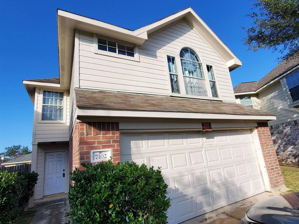 a front view of a house with garage