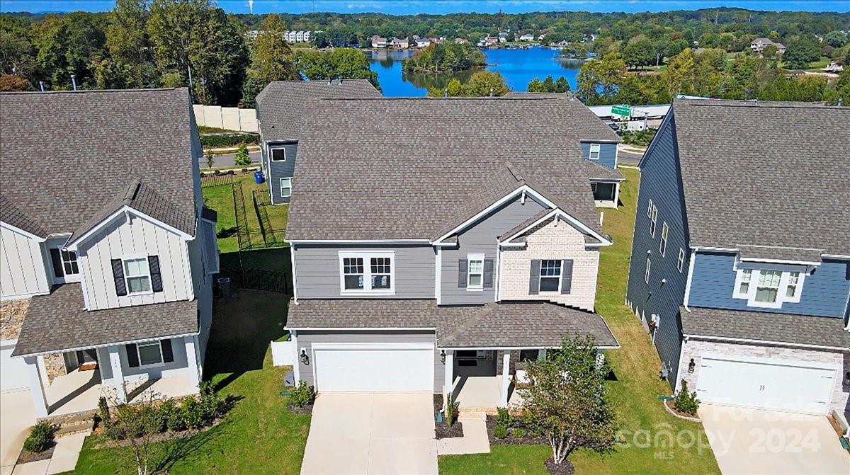 a aerial view of a house with a yard and potted plants