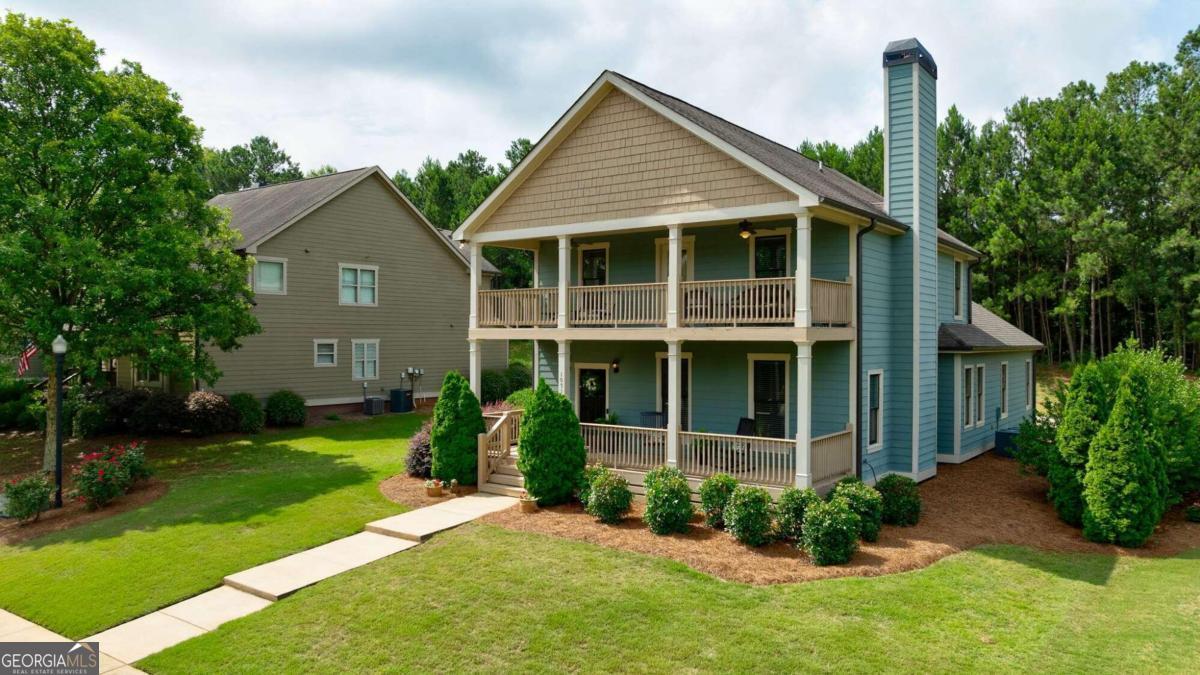 front view of a house with a yard and potted plants