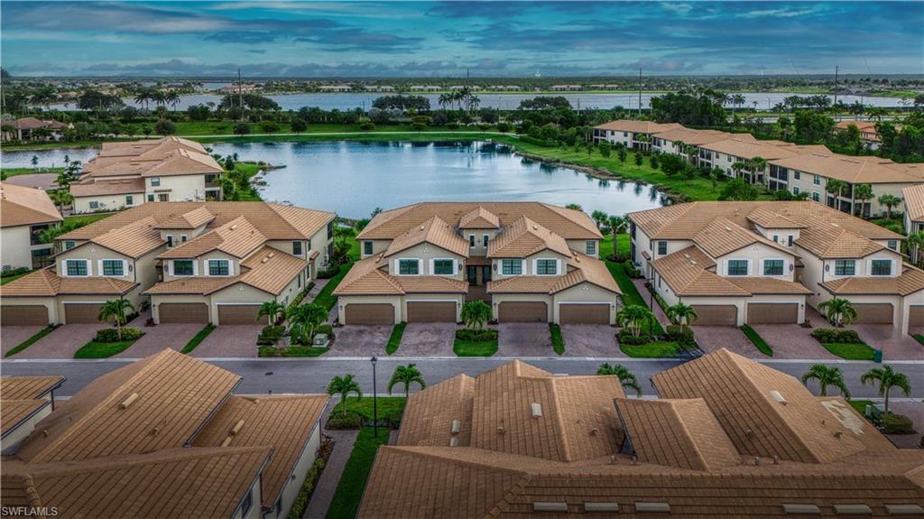 an aerial view of a house with outdoor space lake view and mountain view