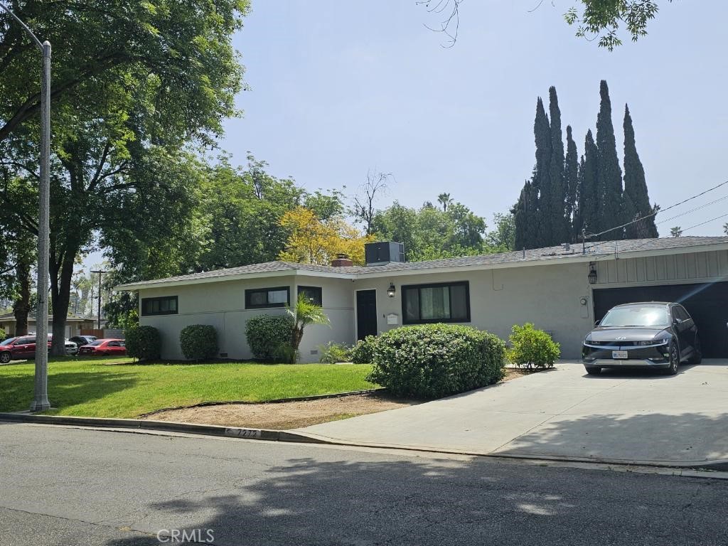 a front view of a house with a garden and plants