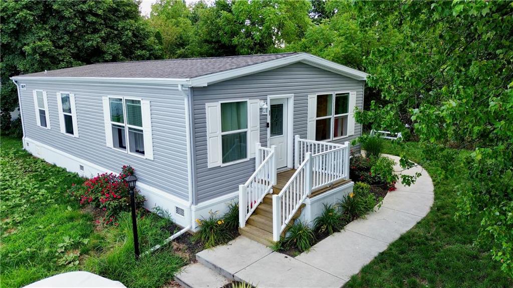 a aerial view of a house with a yard and potted plants