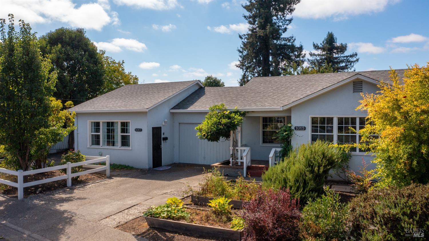 a view of a house with a yard and garden