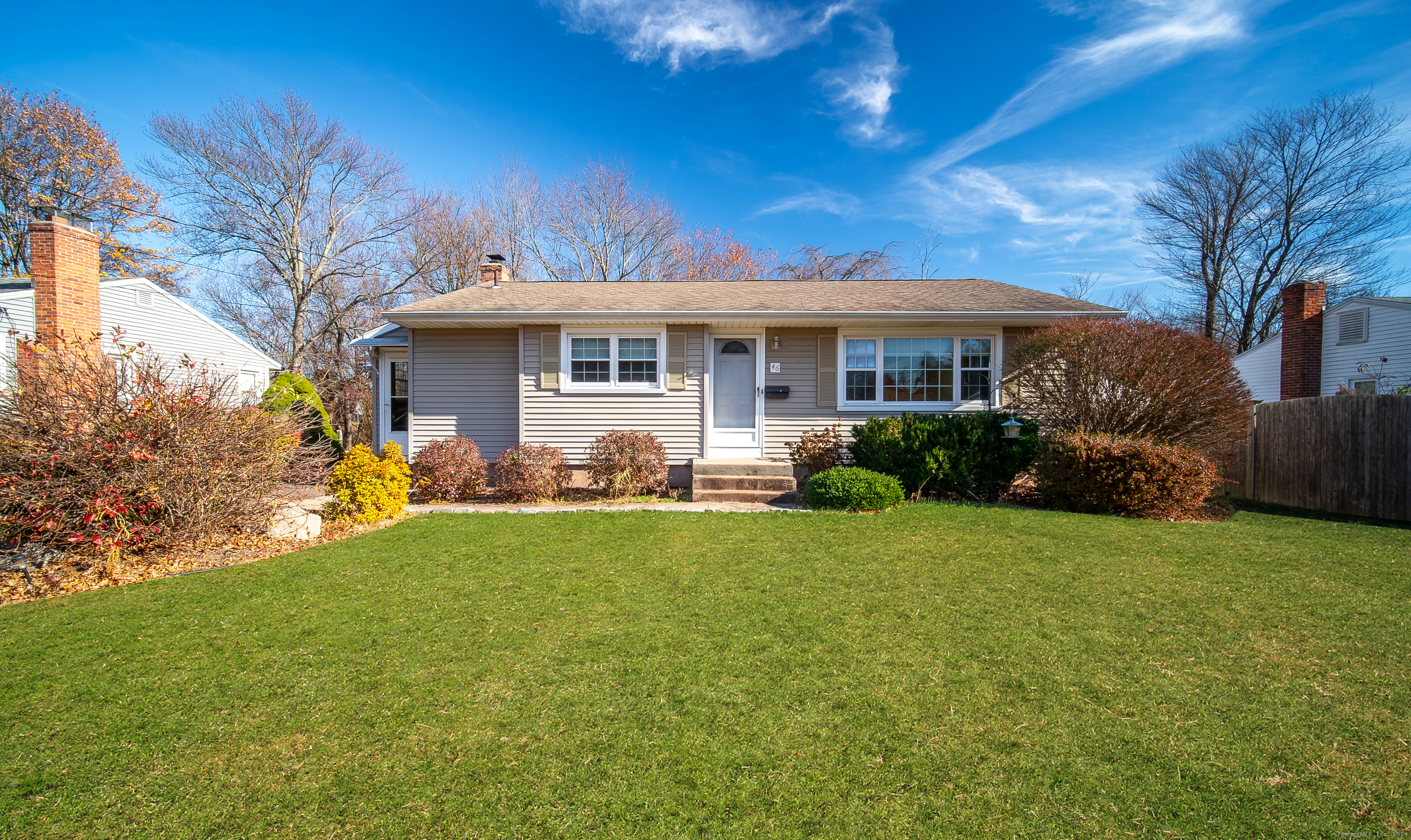 a front view of house with yard and green space