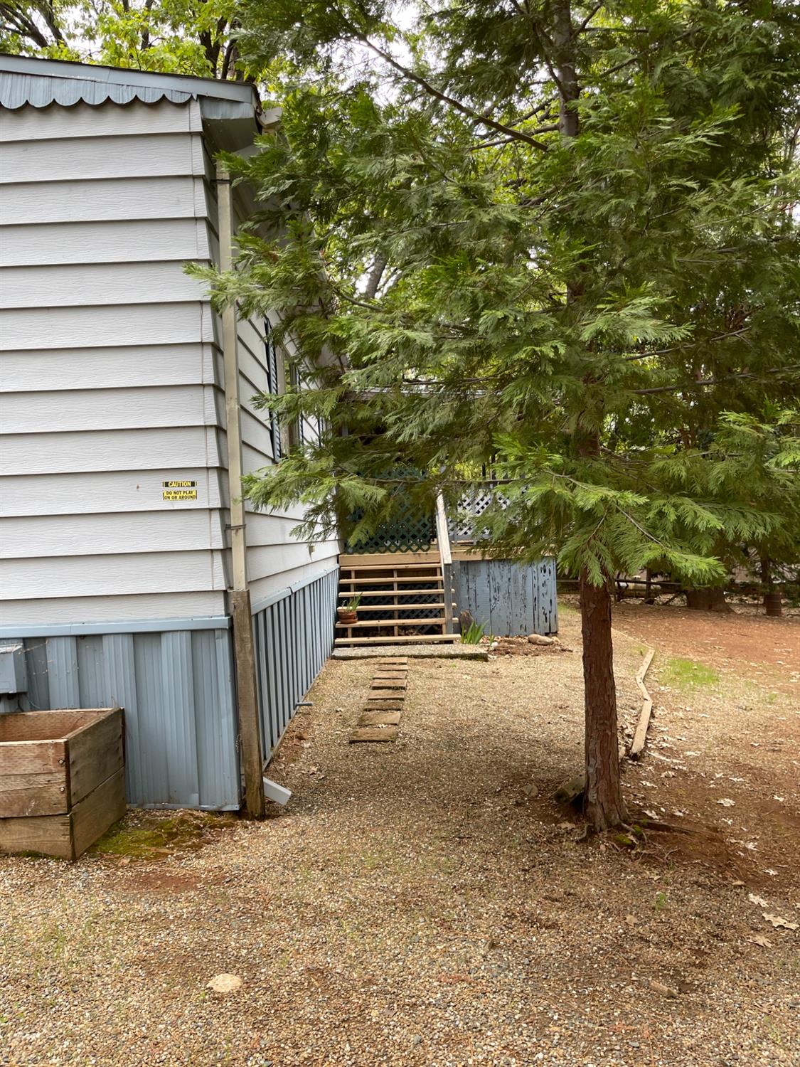 a view of a yard with wooden fence and a stairs