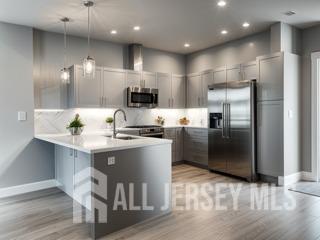 a kitchen with kitchen island stainless steel appliances a sink and refrigerator