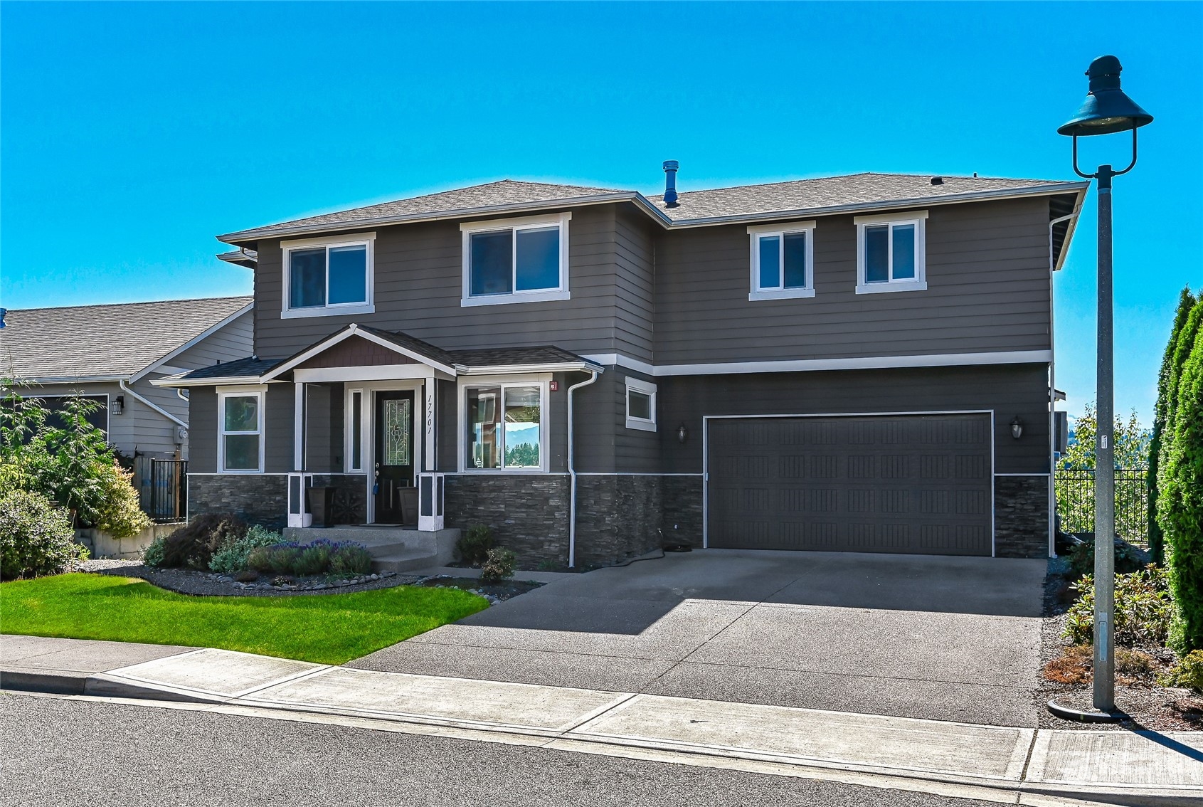 a front view of a house with a yard and garage