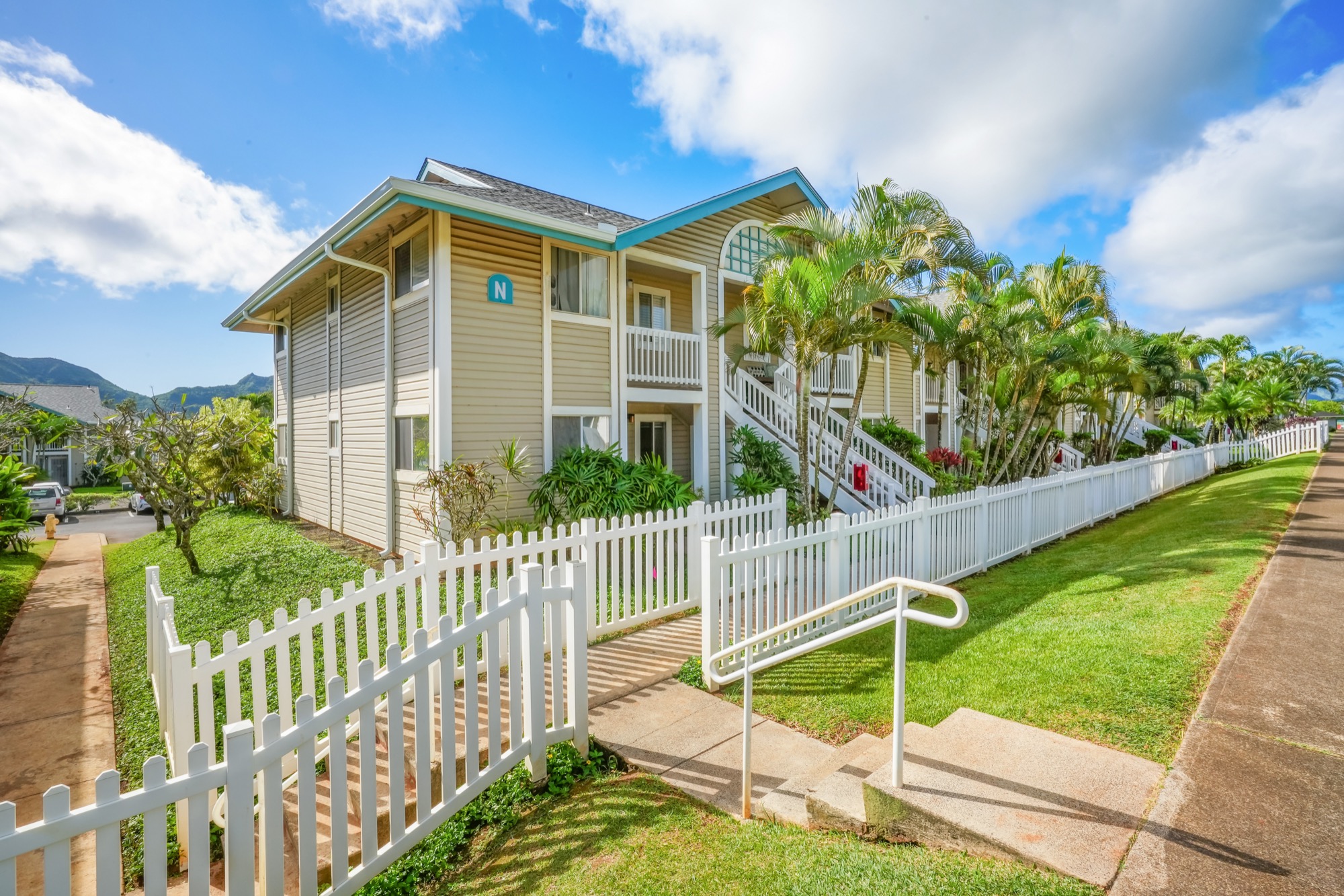 a front view of house with wooden fence