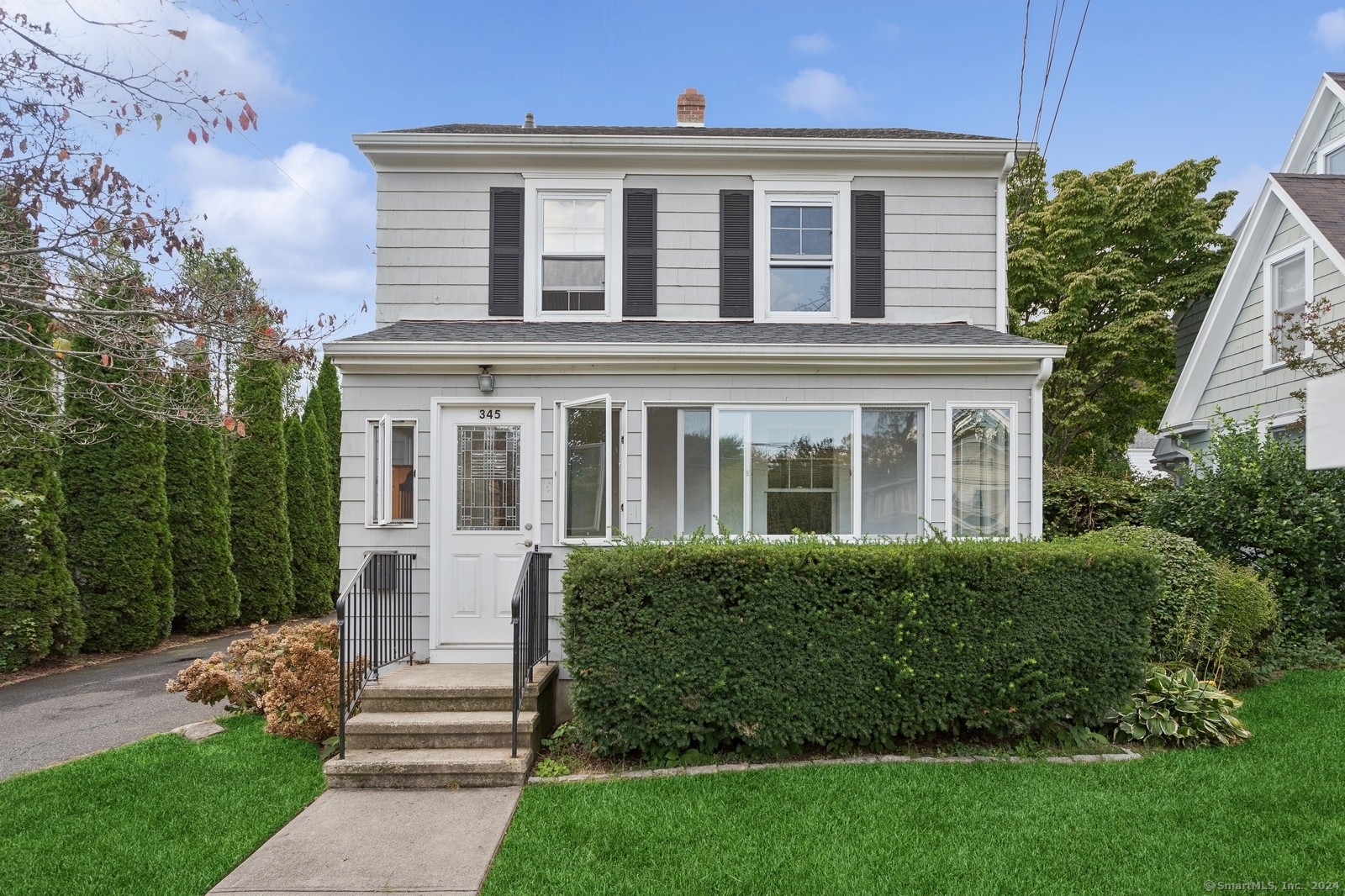 a front view of a house with a garden