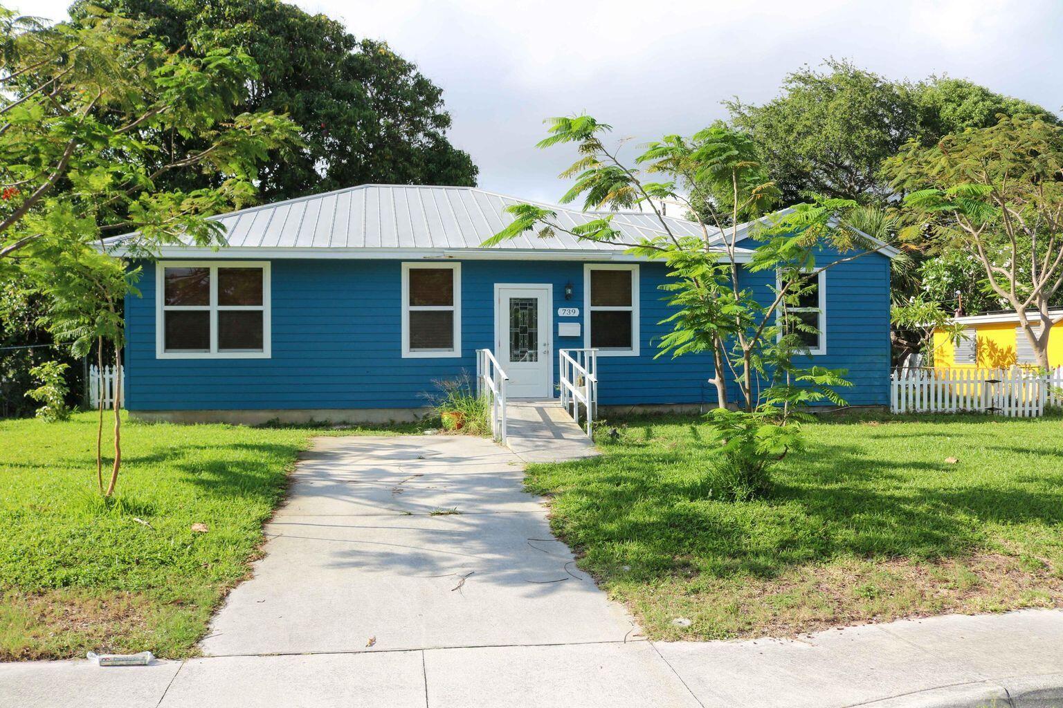 a front view of a house with a yard and porch