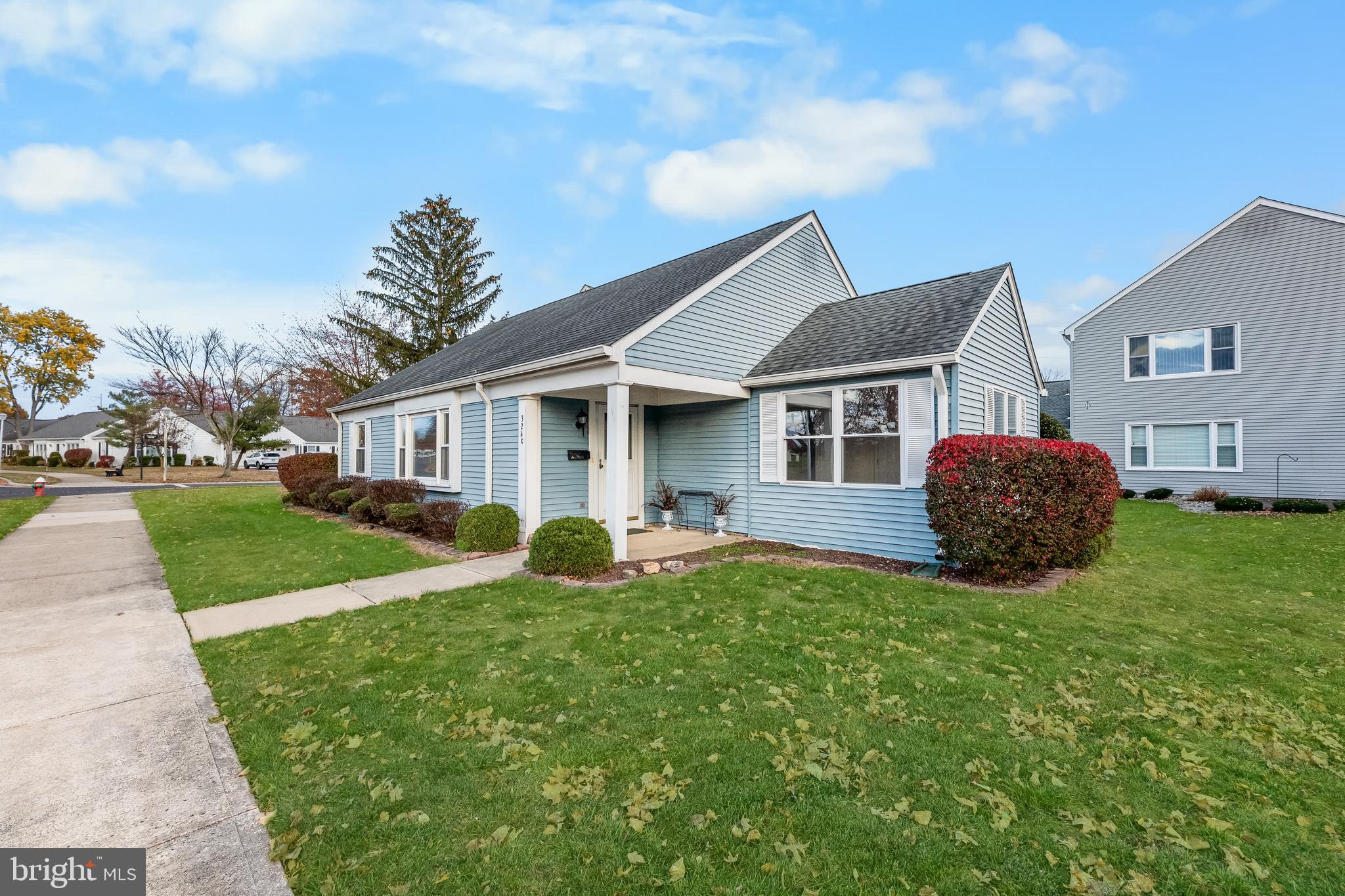 a front view of house with yard and green space