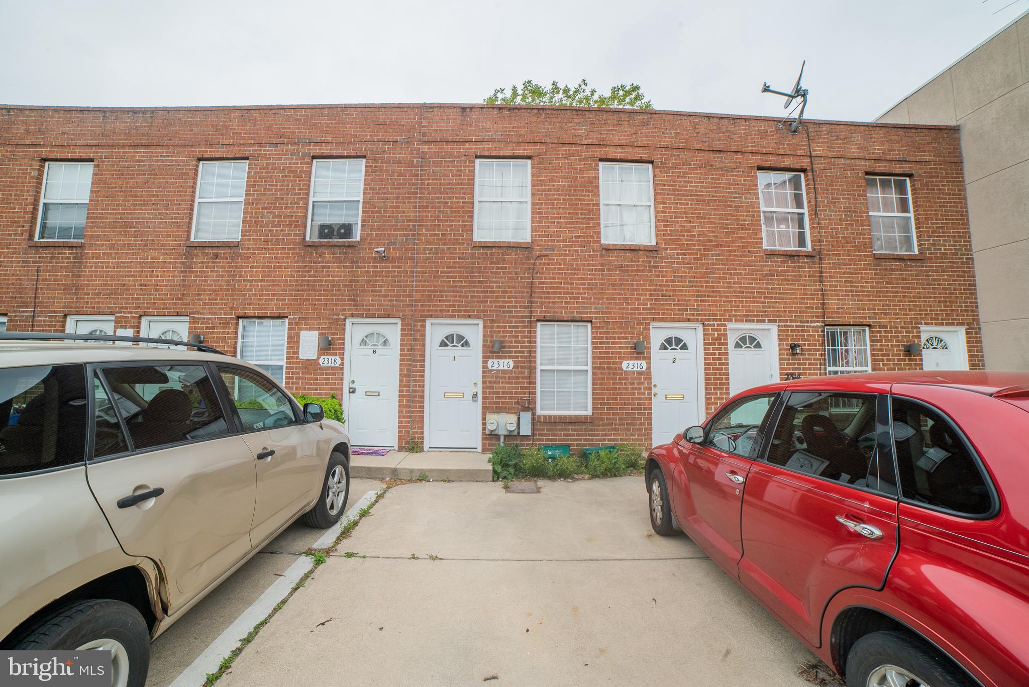 a front view of a house with parking space