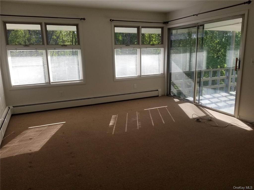 a view of empty room with floor to ceiling windows