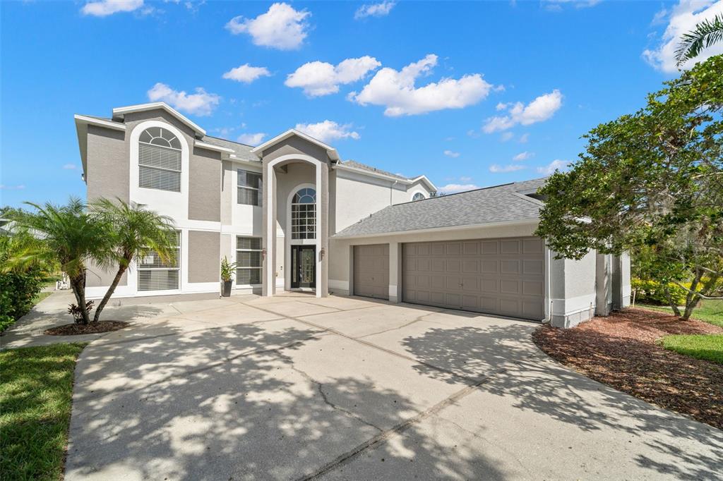 a front view of a house with a yard and garage