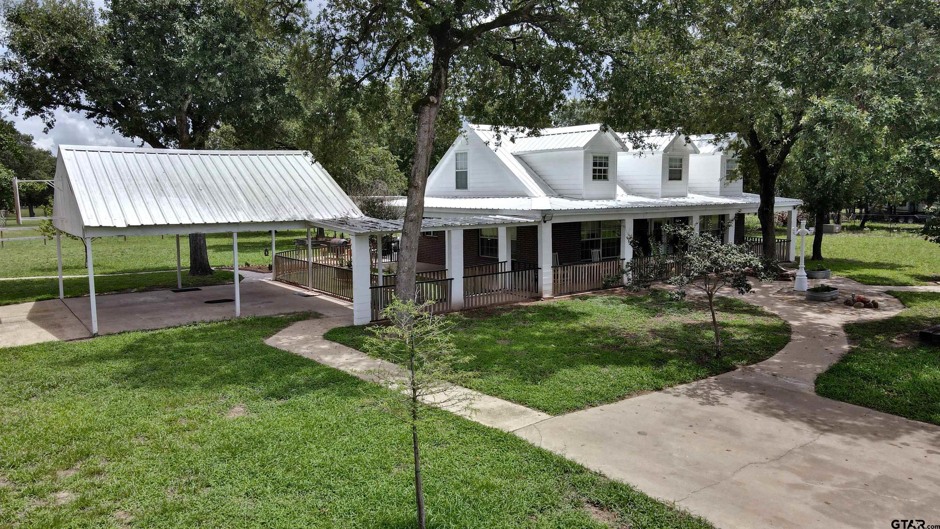 a view of a house with backyard porch and sitting area