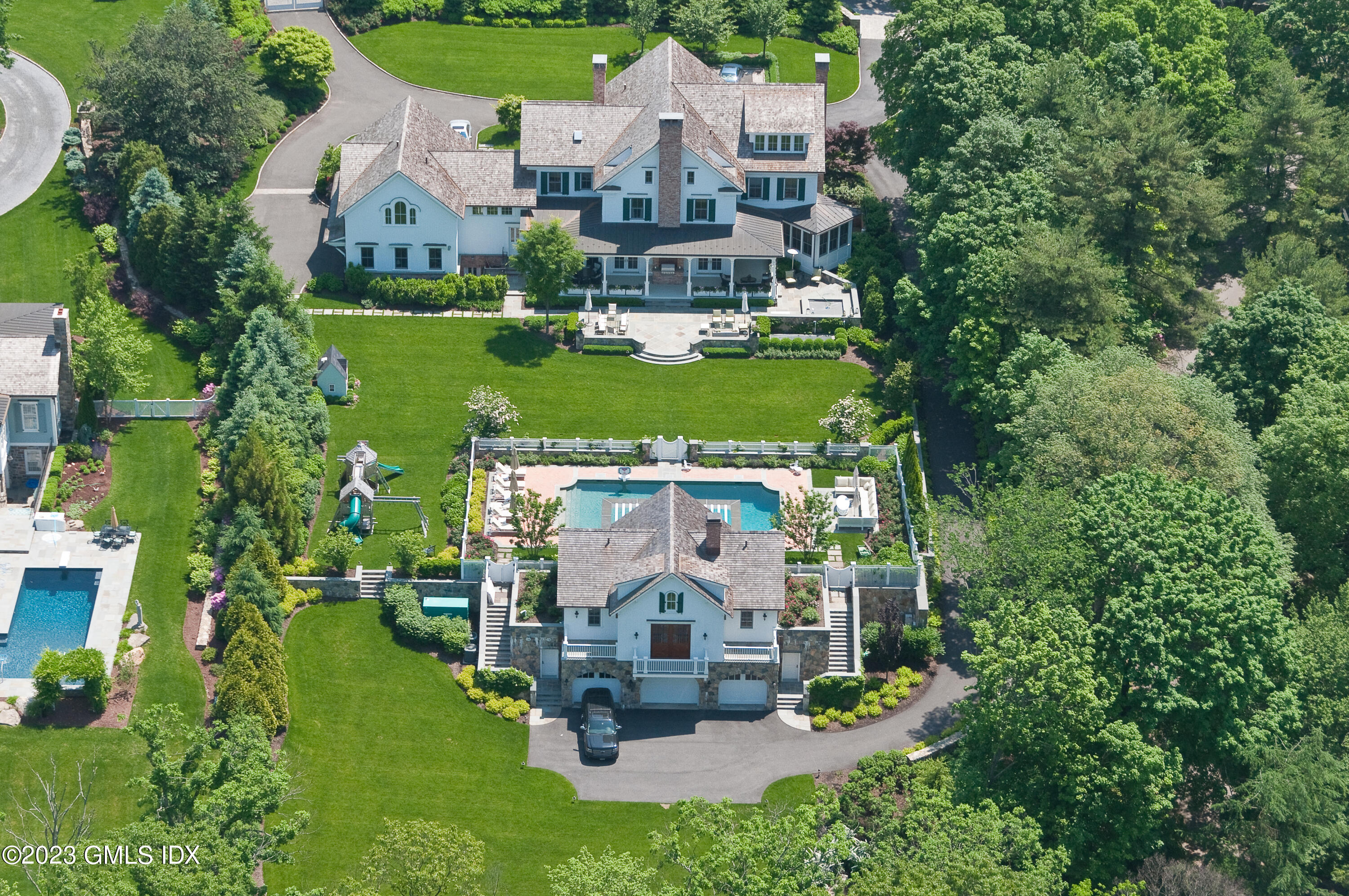 an aerial view of a house with a garden and trees