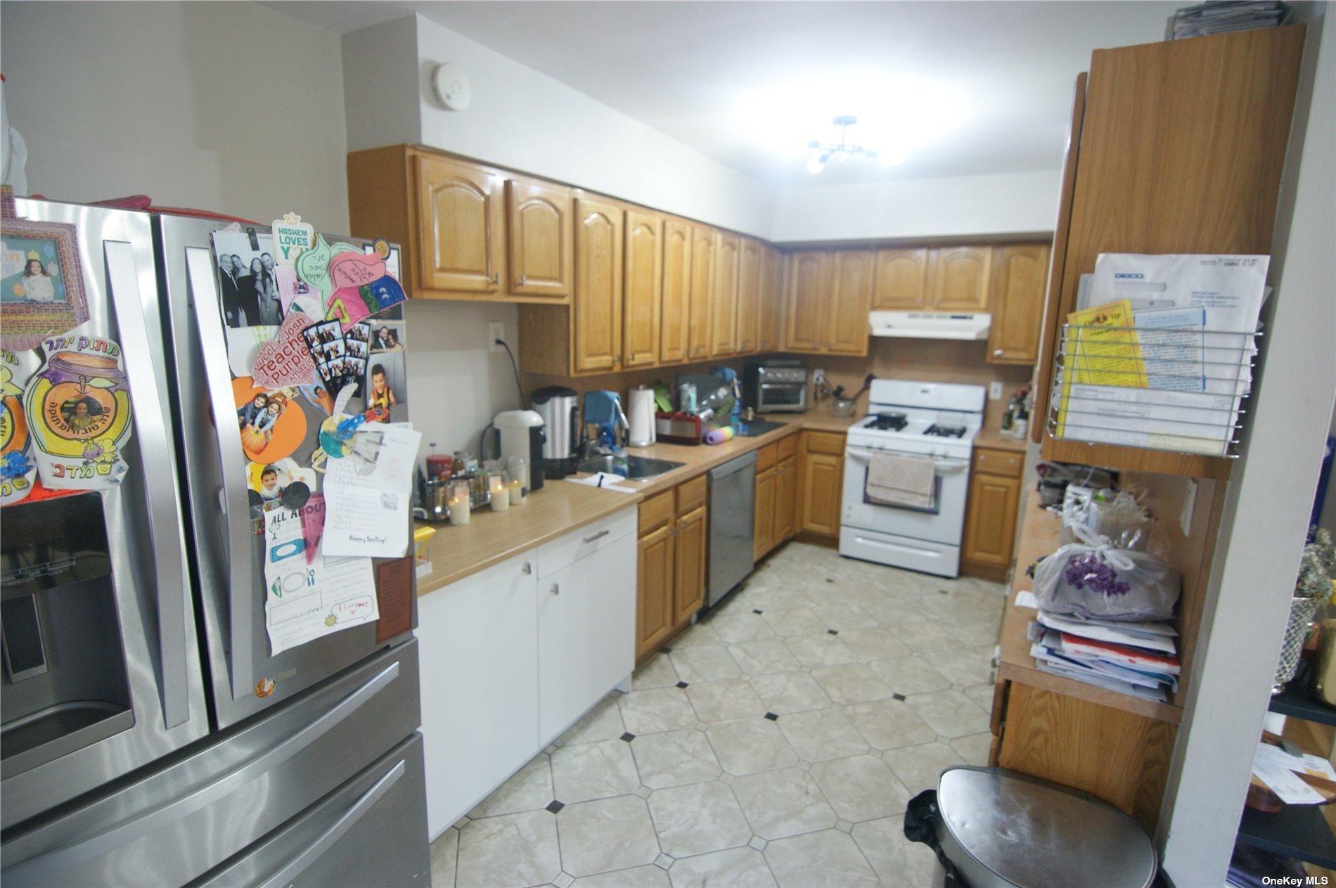 a kitchen with stainless steel appliances a stove a refrigerator and a sink